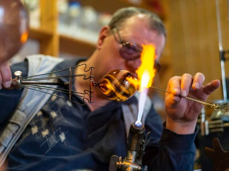 Glass blower forming melting glass